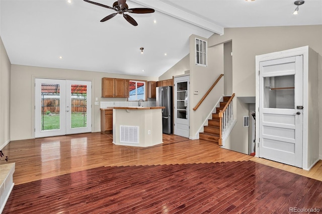 18445 W 59th Dr, Golden, CO 80403 - kitchen with freestanding refrigerator, light wood finished floors, a kitchen island, a ceiling fan, and brown cabinets