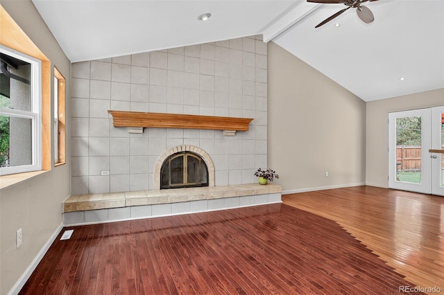 18445 W 59th Dr, Golden, CO 80403 - unfurnished living room with wood finished floors, a tiled fireplace, and ceiling fan