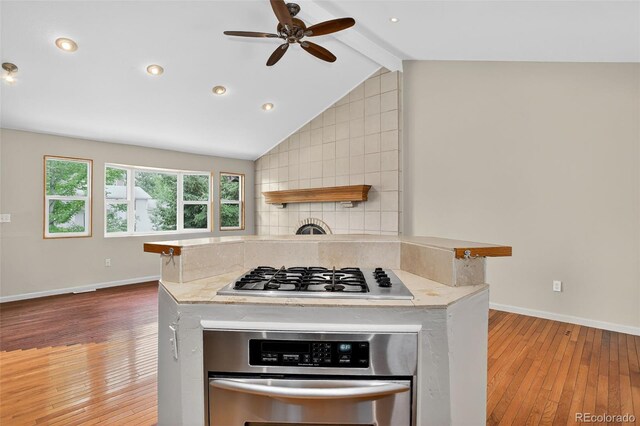 18445 W 59th Dr, Golden, CO 80403 - kitchen featuring stainless steel appliances, hardwood / wood-style flooring, a ceiling fan, decorative backsplash, and recessed lighting