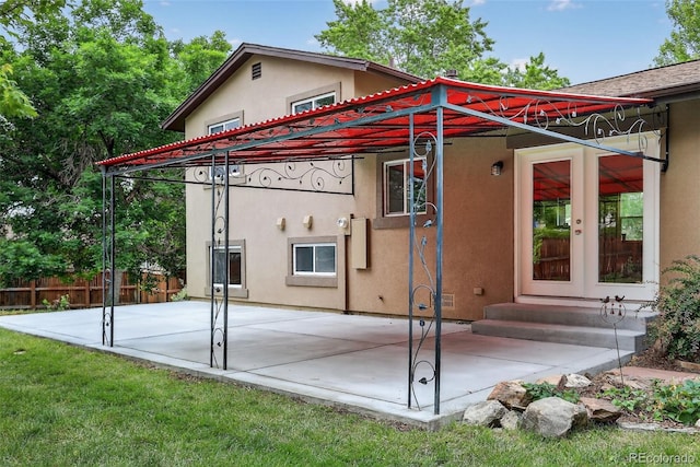 18445 W 59th Dr, Golden, CO 80403 - back of property with stucco siding, a patio, and french doors