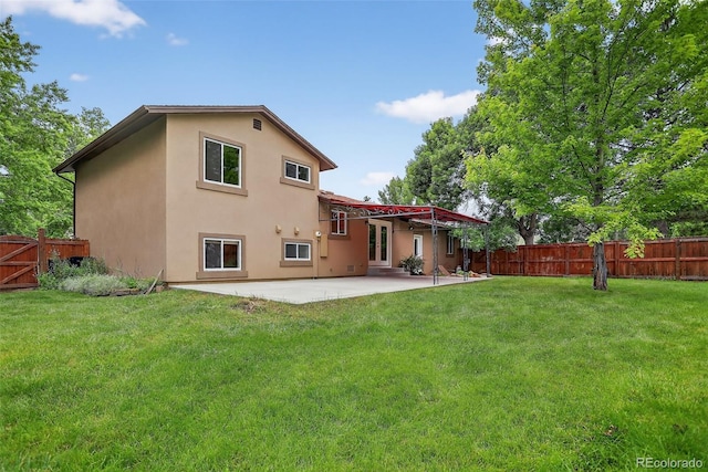 18445 W 59th Dr, Golden, CO 80403 - rear view of house featuring stucco siding, a patio, and a fenced backyard