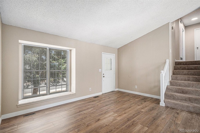 19876 E Brunswick Dr, Aurora, CO 80013 - entryway featuring wood finished floors, stairs, and a textured ceiling