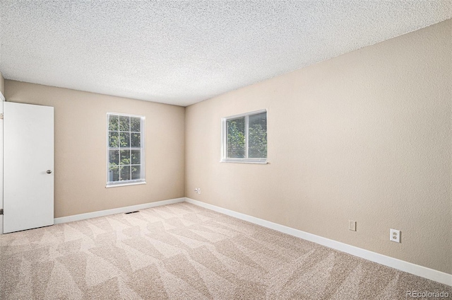 19876 E Brunswick Dr, Aurora, CO 80013 - carpeted empty room with baseboards and a textured ceiling