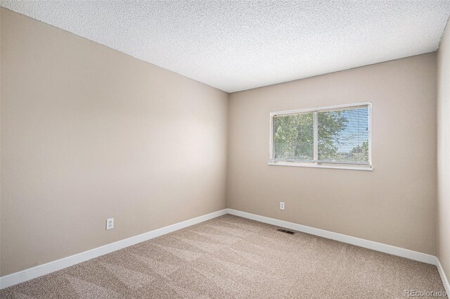 19876 E Brunswick Dr, Aurora, CO 80013 - spare room with light colored carpet and a textured ceiling