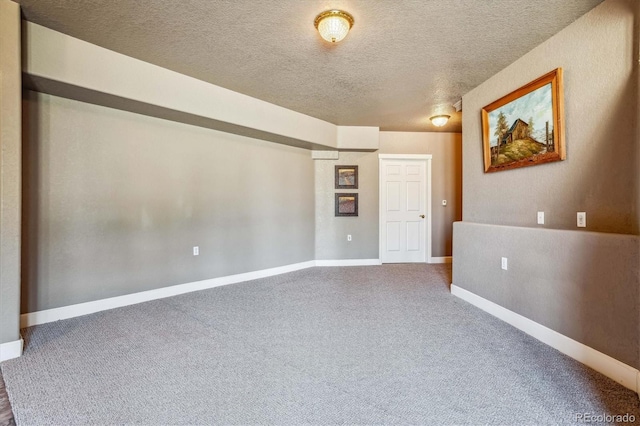 carpeted empty room with a textured ceiling