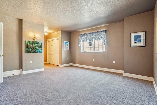 unfurnished room with light carpet and a textured ceiling