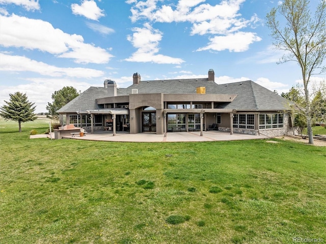 back of house with a yard and a patio