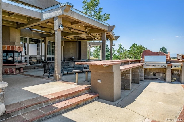 view of patio / terrace with area for grilling and a bar