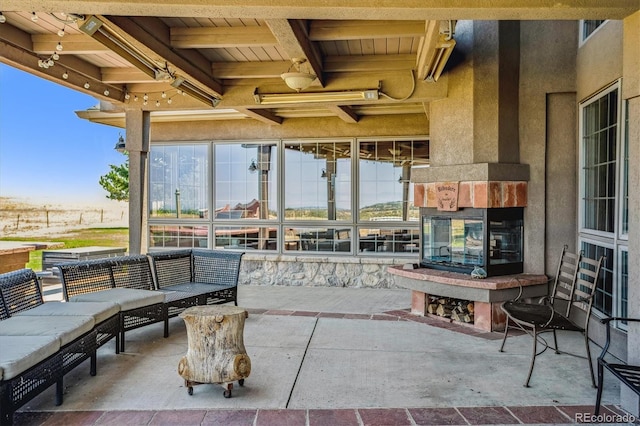 view of patio featuring an outdoor living space with a fireplace