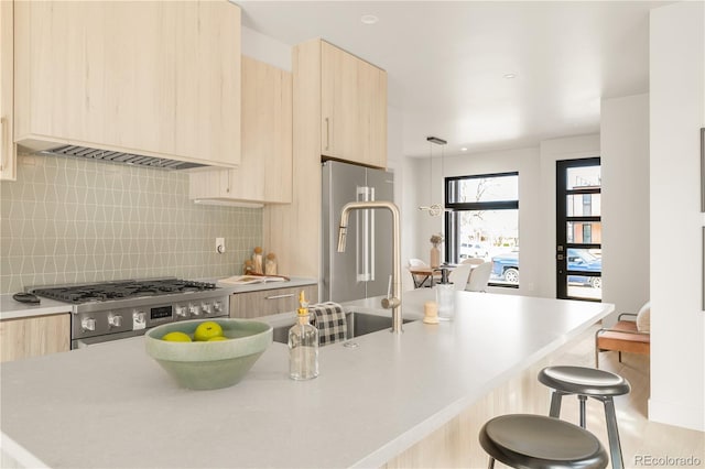 2391 King St, Denver, CO 80211 - kitchen featuring light brown cabinets, modern cabinets, a breakfast bar, and stainless steel gas range oven