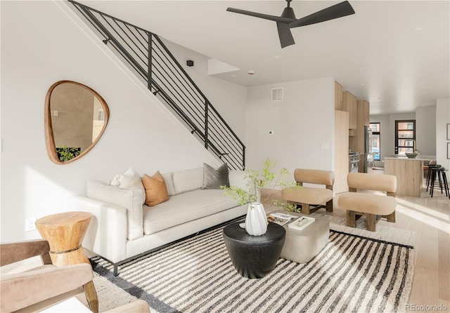 2391 King St, Denver, CO 80211 - living room featuring wood finished floors, ceiling fan, and stairs