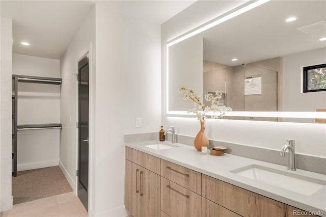 2391 King St, Denver, CO 80211 - bathroom featuring double vanity, recessed lighting, a spacious closet, and a tile shower