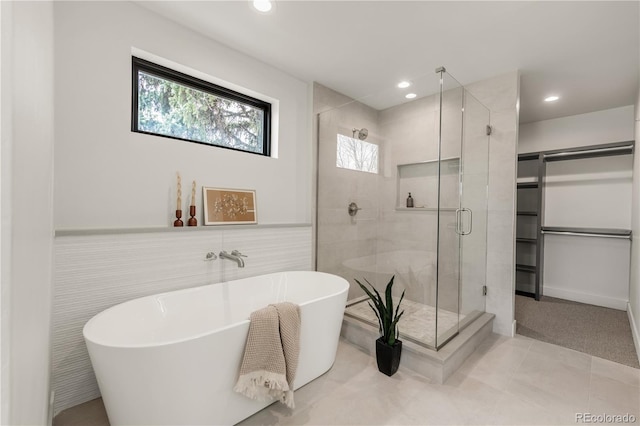 2391 King St, Denver, CO 80211 - bathroom featuring a freestanding tub, a stall shower, recessed lighting, a spacious closet, and tile patterned floors