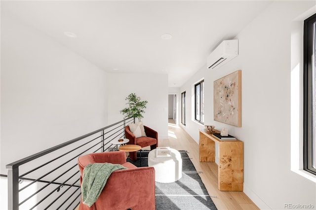 2391 King St, Denver, CO 80211 - hallway with an AC wall unit, light wood-style floors, and an upstairs landing