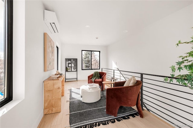 2391 King St, Denver, CO 80211 - living area with an AC wall unit, wood finished floors, and recessed lighting