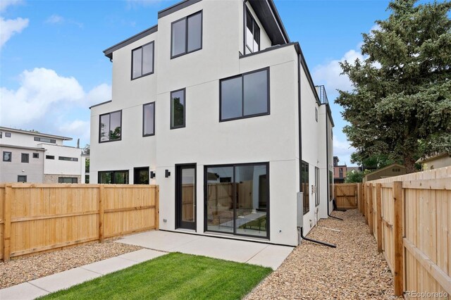 2391 King St, Denver, CO 80211 - rear view of house featuring stucco siding, a fenced backyard, and a patio