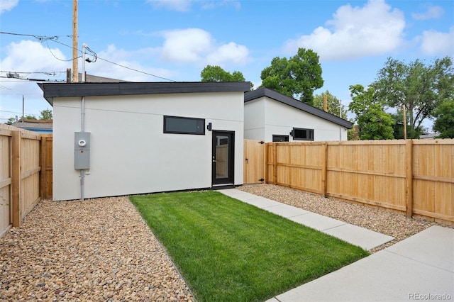 2391 King St, Denver, CO 80211 - rear view of house with a fenced backyard and stucco siding