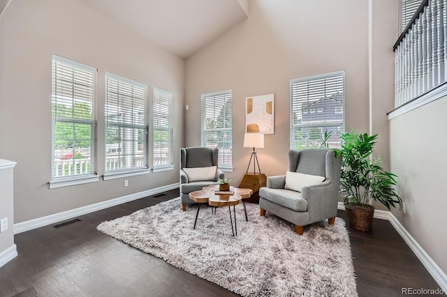 8469 Winter Berry Dr, Castle Pines, CO 80108 - sitting room with healthy amount of natural light, dark wood finished floors, baseboards, and high vaulted ceiling
