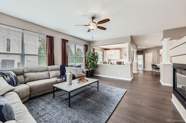 8469 Winter Berry Dr, Castle Pines, CO 80108 - living area featuring ornate columns, ceiling fan, baseboards, dark wood-style floors, and recessed lighting