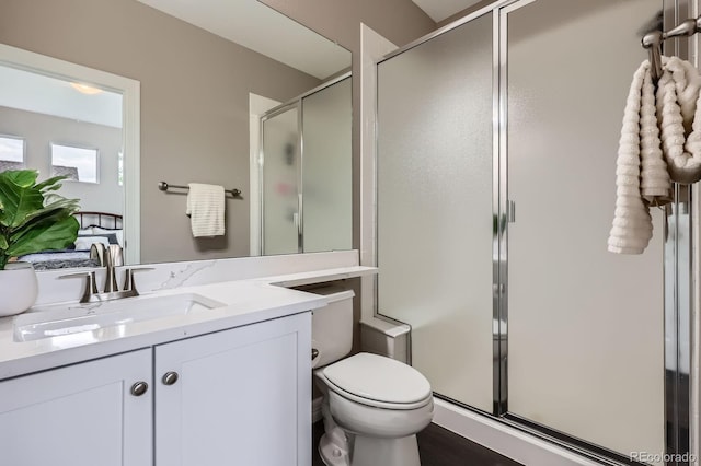 8469 Winter Berry Dr, Castle Pines, CO 80108 - bathroom with a shower stall, vanity, and toilet