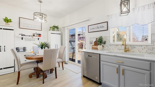 dining room featuring light wood-type flooring and an inviting chandelier