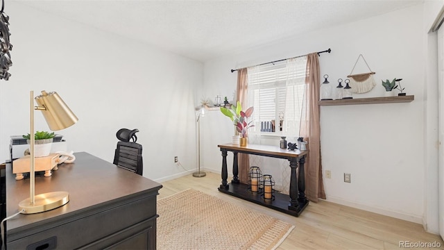 home office featuring baseboards and light wood-style floors