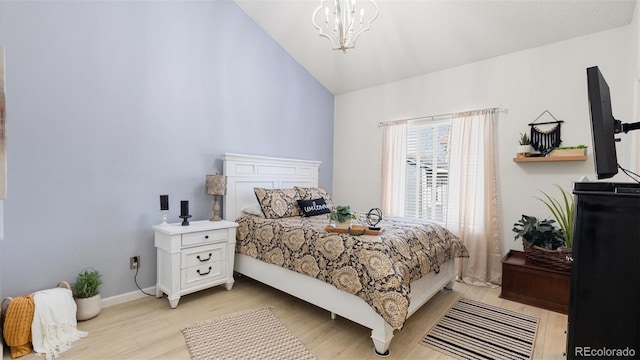 bedroom featuring a chandelier, baseboards, light wood-style floors, and vaulted ceiling