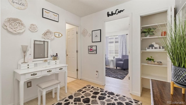 bathroom featuring baseboards and wood finished floors