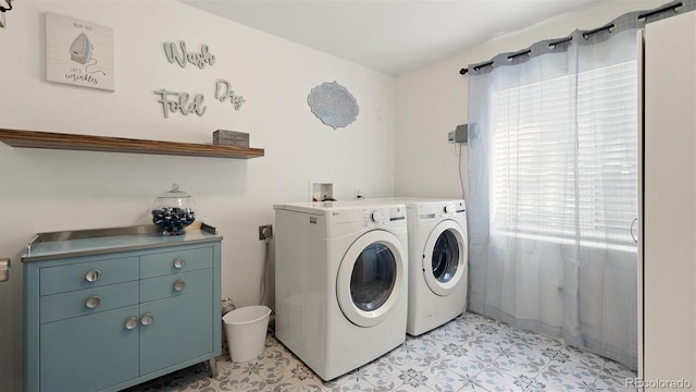 laundry area with washing machine and clothes dryer, laundry area, and light floors