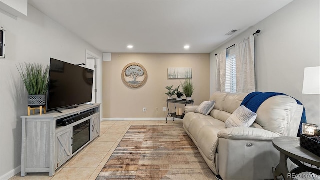 living area featuring recessed lighting, light tile patterned floors, baseboards, and visible vents