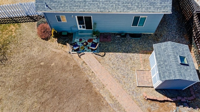 back of property with roof with shingles