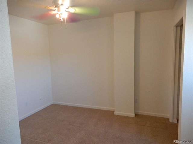 spare room featuring ceiling fan and carpet flooring