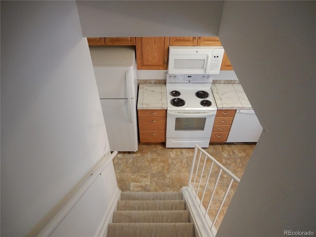 kitchen with white appliances and tile countertops