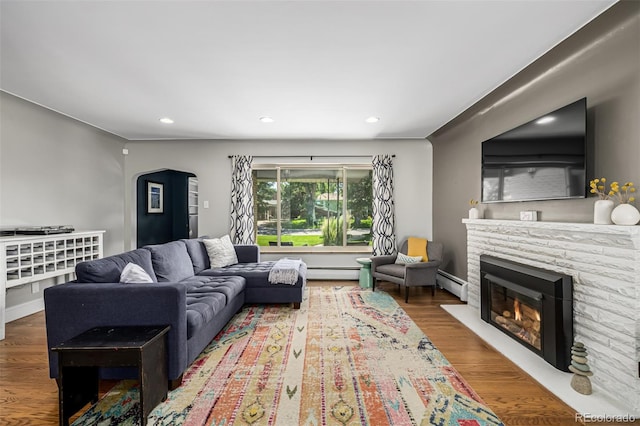 2845 Hudson St, Denver, CO 80207 - living room with baseboard heating, recessed lighting, wood finished floors, a fireplace, and arched walkways