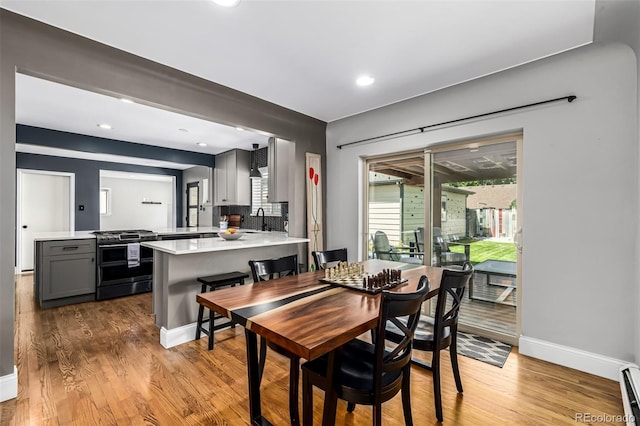 2845 Hudson St, Denver, CO 80207 - dining space with wood finished floors, recessed lighting, and a baseboard radiator
