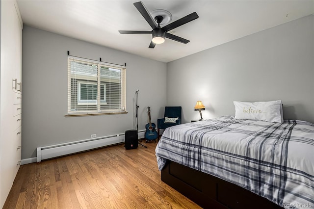 2845 Hudson St, Denver, CO 80207 - bedroom featuring baseboard heating, wood finished floors, and a ceiling fan