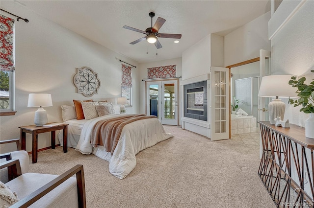 carpeted bedroom with french doors, multiple windows, a ceiling fan, and access to outside