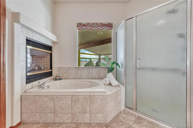 bathroom featuring a garden tub, a stall shower, and vaulted ceiling