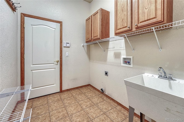 laundry room featuring washer hookup, a sink, cabinet space, light tile patterned floors, and hookup for an electric dryer