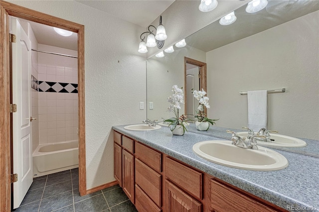 full bathroom with a sink, double vanity, and tile patterned flooring