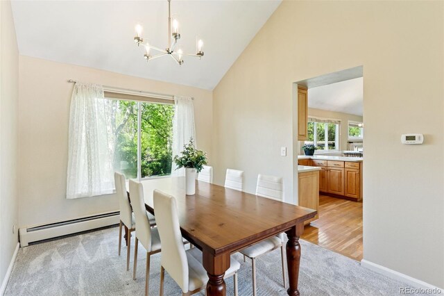 6083 S Glencoe Way, Centennial, CO 80121 - dining area featuring a baseboard heating unit, light carpet, a chandelier, high vaulted ceiling, and baseboards
