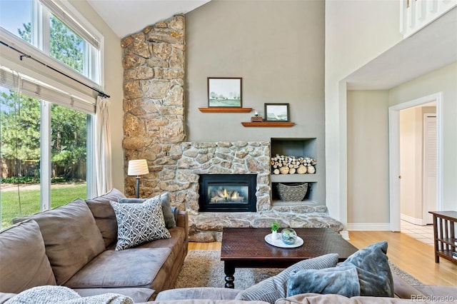6083 S Glencoe Way, Centennial, CO 80121 - living room with high vaulted ceiling, wood finished floors, a fireplace, and baseboards