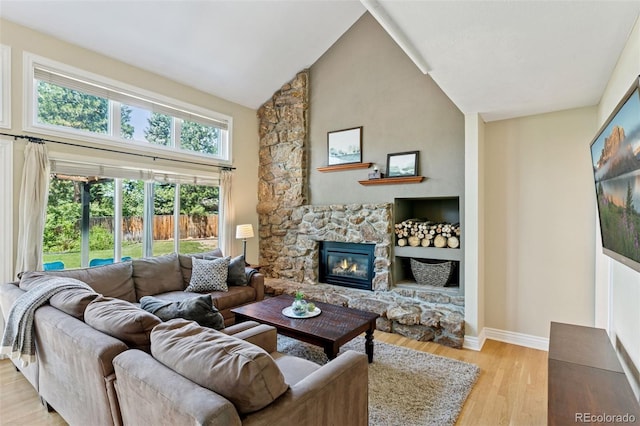 6083 S Glencoe Way, Centennial, CO 80121 - living room with light wood-style flooring, baseboards, a fireplace, and high vaulted ceiling