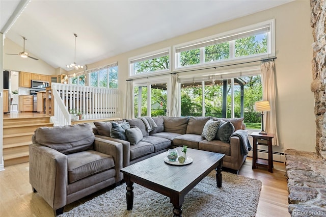 6083 S Glencoe Way, Centennial, CO 80121 - living area featuring light wood-type flooring, a baseboard radiator, high vaulted ceiling, a chandelier, and a ceiling fan