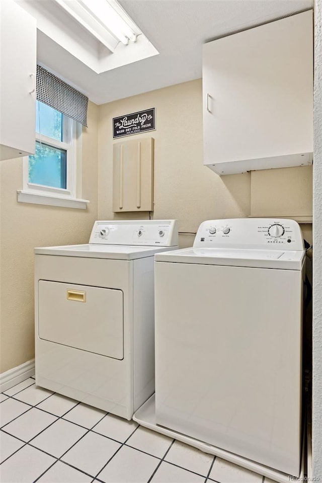 6083 S Glencoe Way, Centennial, CO 80121 - laundry room with washing machine and dryer, cabinet space, and light tile patterned floors