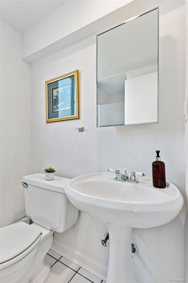 6083 S Glencoe Way, Centennial, CO 80121 - bathroom featuring toilet, tile patterned floors, and a sink