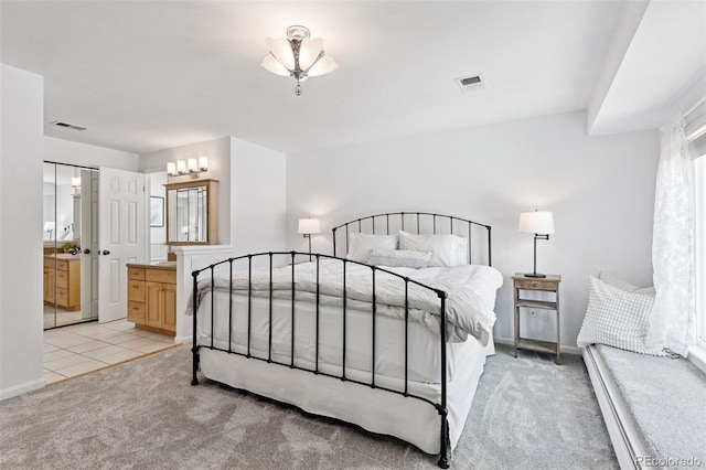 6083 S Glencoe Way, Centennial, CO 80121 - bedroom with light colored carpet, baseboard heating, baseboards, and ensuite bathroom