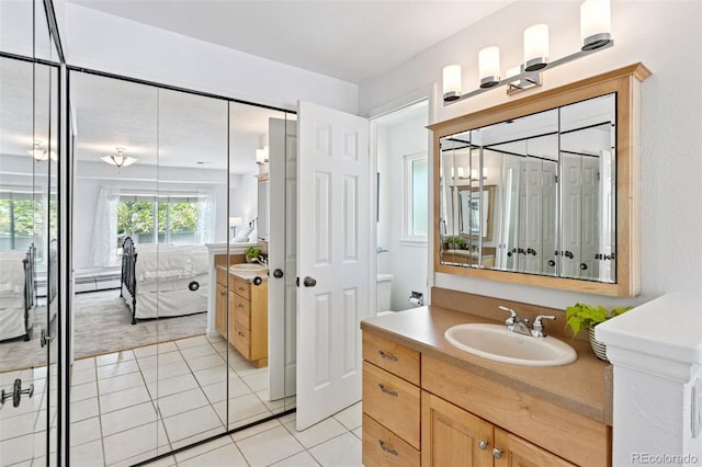 6083 S Glencoe Way, Centennial, CO 80121 - ensuite bathroom featuring vanity and tile patterned flooring
