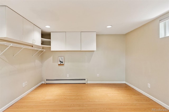 6083 S Glencoe Way, Centennial, CO 80121 - washroom with baseboard heating, light wood finished floors, washer hookup, baseboards, and recessed lighting