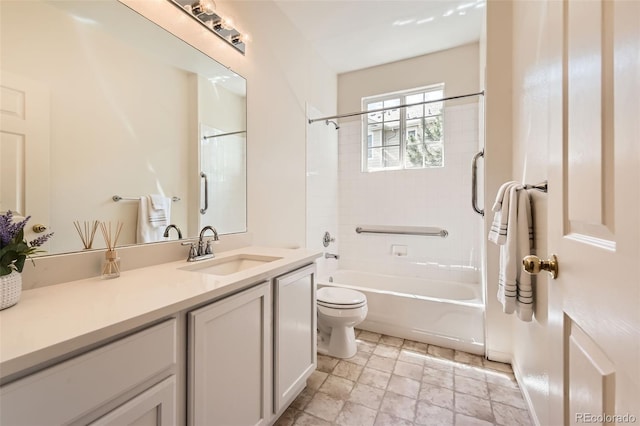 full bathroom with toilet, vanity, shower / tub combination, and stone finish floors